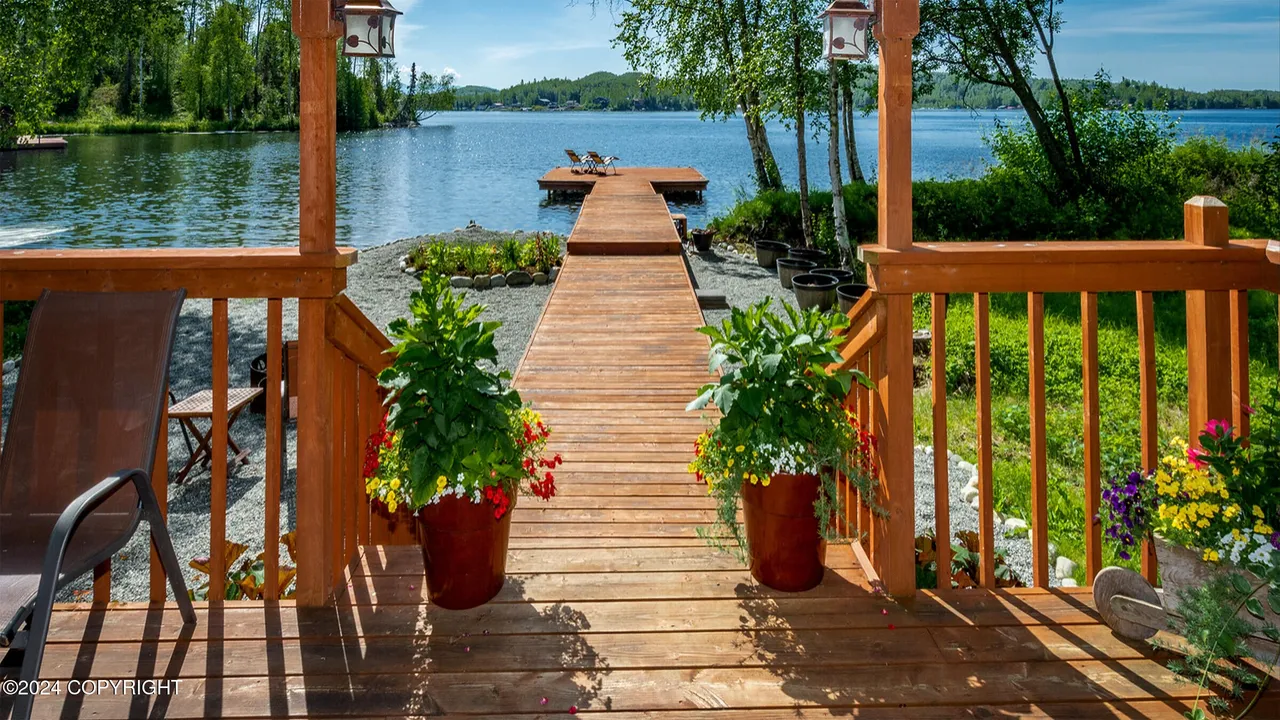Long dock extending into Big Lake from gravel beach