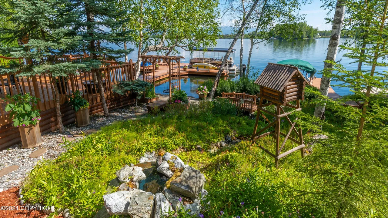 Elevated view of garden water feature, bridge, and dock