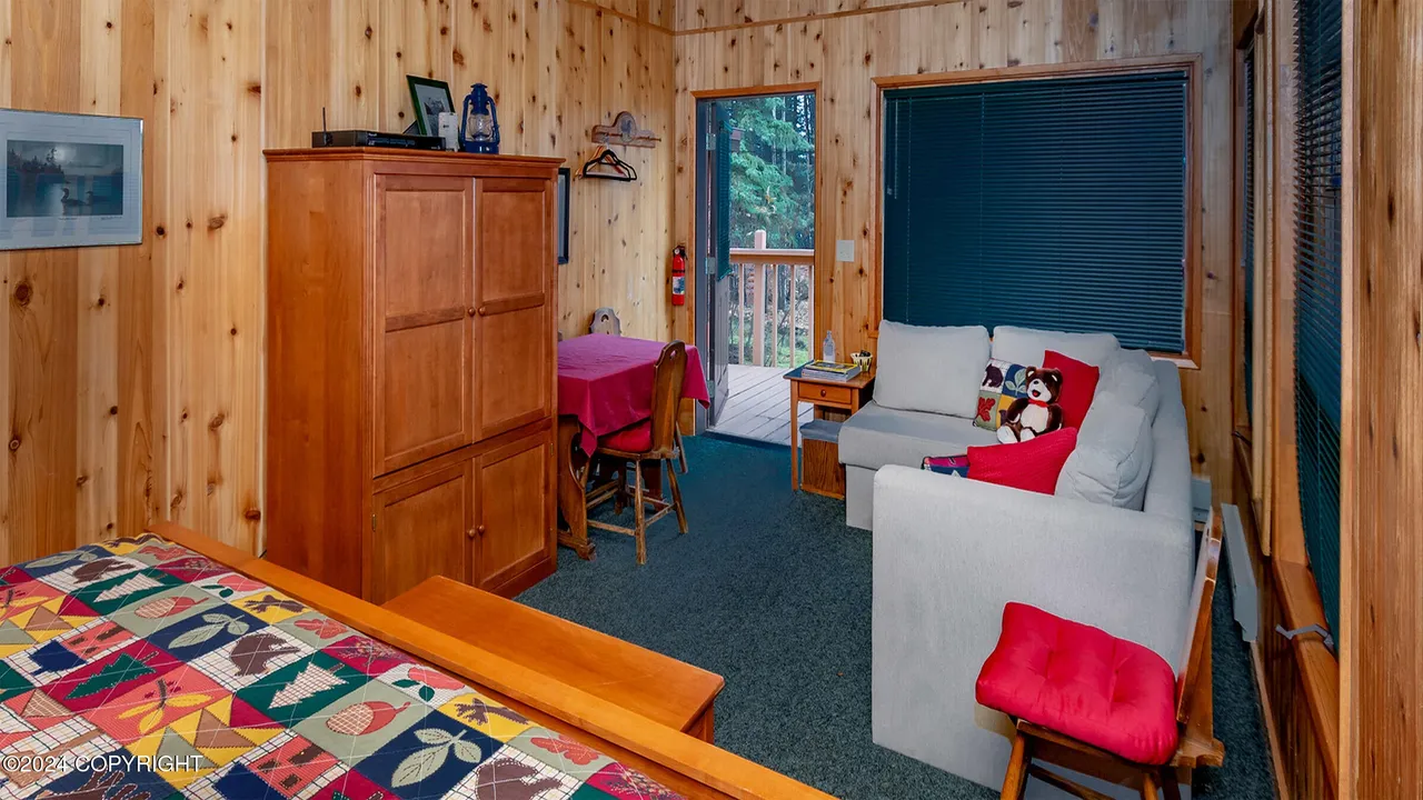Guest cabin sitting area with sofa bed and deck access