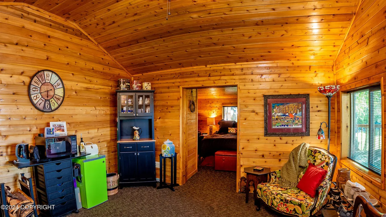 Guest cabin interior with kitchenette and arched ceiling