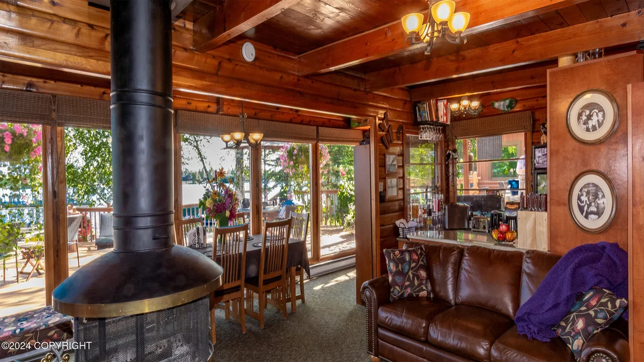 Central round wood-burning fireplace with the lake doors open behind