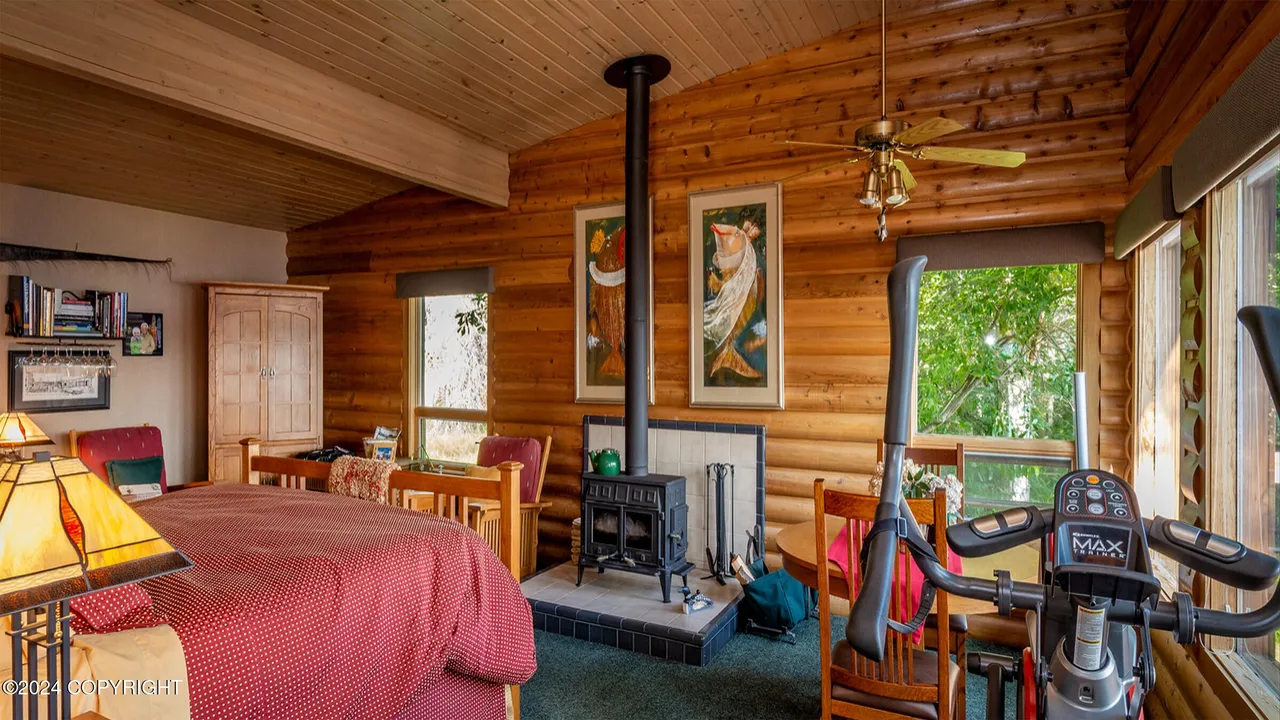 Secondary bedroom in the main cabin with second wood stove