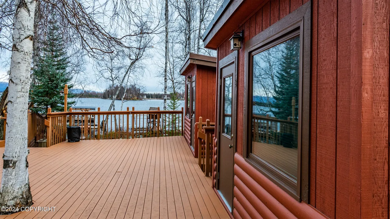 Twin guest cabins porch looking out to the lake in autumn
